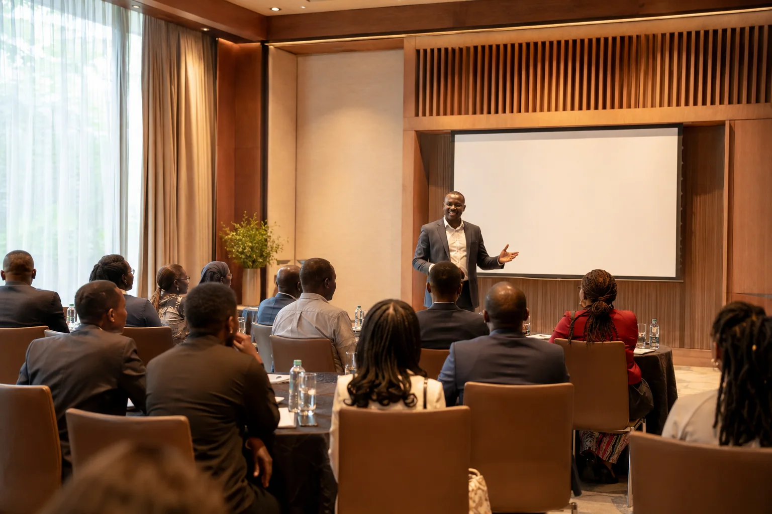 Business delegates listening to a speaker in a conference room